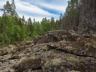 Sheer cliffs and large stones in the forest in the Republic of Karelia, northwest Russia