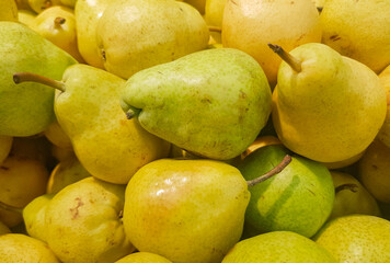 Food background yellow and green fresh ripe pears, close-up view from above, organic fruit concept