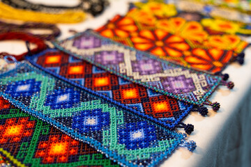 Colorful huichol bracelets at night market in Guadalajara, Mexico. Traditional Mexican handcraft...