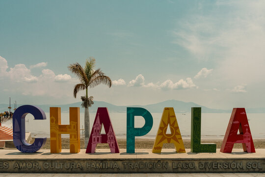 Chapala, Guadalajara, Mexico - May 10, 2022: Colorful Chapala word letters sign by lake on sunny day in Jalisco State. Vintage effect applied