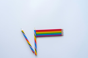Pride concept with rainbow pencils laid out in the Pride flag on white background.