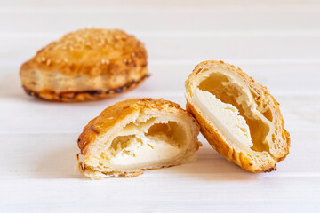 Israeli Savory Cheese Pastry Bourekas on white wooden background.