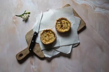 Top view of snack item quiche on a wooden board with use of selective focus