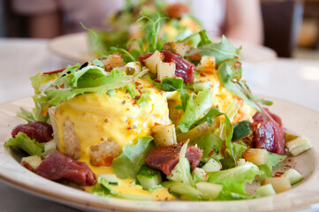 Cooked dish with lettuce salad leaves and tuna served on plate restaurant food