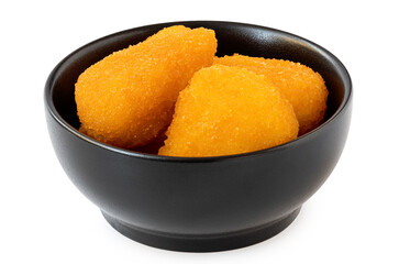 Fried breaded brie nuggets in a black ceramic bowl on white.