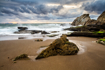 Fototapeta na wymiar Sunset at Azkorri beach in the coast of Biscay, Basque Country, north of Spain. 