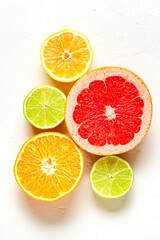 Fresh lemon, orange, grapefruit, lime on light background, top view.