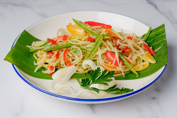 Green papaya salad close up on a plate, Thai cuisine