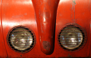 Red vintage motorcar detailed photo.  Close up photo of old fashioned vehicle. 