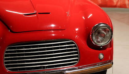 Red vintage motorcar detailed photo.  Close up photo of old fashioned vehicle. 