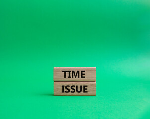 Time issue symbol. Wooden blocks with words Time issue. Beautiful green background. Business and Time issue concept. Copy space.