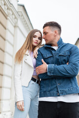 Beautiful young fashionable couple in trendy stylish casual denim clothes in town