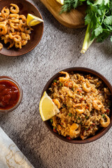 Spanish dish with shrimp. Fresh vegetables. Shrimp and lemon. Vertical frame.