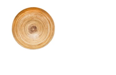 A photography of textured surface of light wooden round plate. White wall as a background of picture of natural materials with structural lack worn wholes, ugly dirty cracked rustic craft stile.