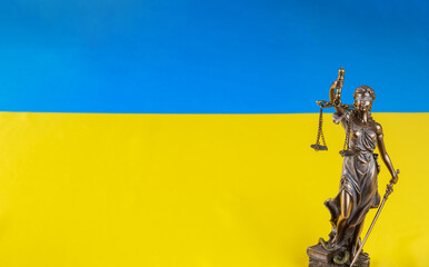 On the Ukrainian flag is a statue of Lady Justice holding the scales. Stop war.