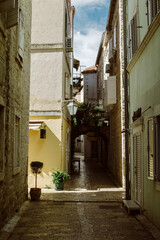 Fototapeta na wymiar Beautiful street in Budva old town, Montenegro. Summer sunny day.