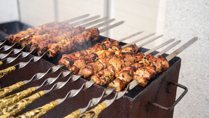 Shish kebab of meat or shashlik or shashlyk on skewers is fried on the grill. Cooking outdoors. Picnic food