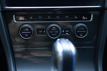 Modern car climate control panel for driver and passenger with shallow depth of field. Zone climate control. Car interior detail. Car air conditioning button inside a car