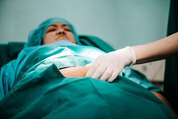 Doctor using a hand to hold the belly fat Of obese woman patients, who received treatment for...