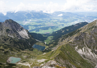 Fototapeta na wymiar View over two romantic alpine lakes from a ridge