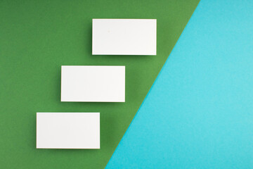 Business card blank over colorful background. Copy space for text. Top view.Business card blank over colorful abstract background. Corporate stationery branding mock-up. Copy space for text. Top view.