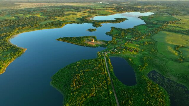 Lake in rural, aerial view. Freshwater Lakes. Abandoned Trinity Church in village of Belaya Tserkov. Lake Chereiskoye in Chereya village. Lighthouse on island. Panoramic landscape view of river.