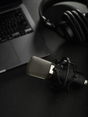 Home Office. Studio microphone, headphones and laptop on a gray background. Journalism, radio, blogging, presentations, software, audio, podcast. Banner, advertisement, poster.