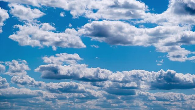 Timelapse of cumulus clouds moving in the blue sky. Light layered clouds change their shape in cloud space. Awesome sky. Background of cloudscape, time-lapse. Copy space. Change of weather. Nature. 4K
