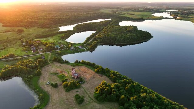 Lake in rural, aerial view. Freshwater Lakes. Abandoned Trinity Church in village of Belaya Tserkov. Lake Chereiskoye in Chereya village. Lighthouse on island. Panoramic landscape view of river.