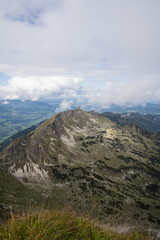 View to an Alpine valley with clouds