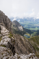 Breathtaking view from the ridge to the valley with a romantic lake