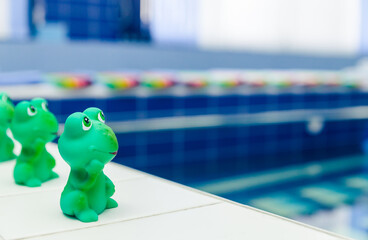 Swimming pool in kindergarten. Rubber toy frog on the side of the pool.