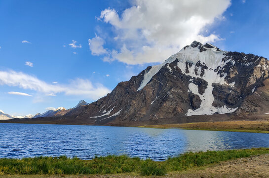 Koramber lake with rocky mountains tree barren mountains clean blue water ice peaks travel adventure Pakistan