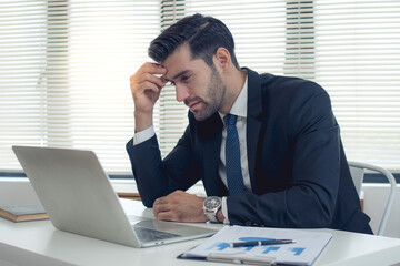 Stressed anxiety businessman nervous and headache because mistake from his job in working office