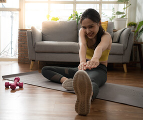 Young woman preparing to stretch before exercise in her spare time at home.