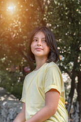 Bottom view, portrait of a teenager girl in a yellow T-shirt.