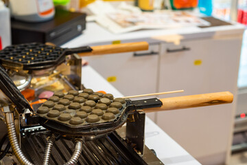Hong Kong charcoal Waffle is baked on waffle iron machine.