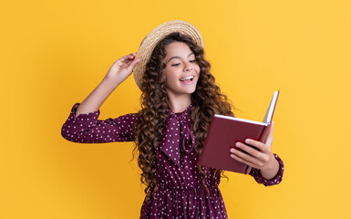 happy child with frizz hair recite book on yellow background