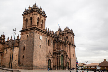 Fototapeta na wymiar View of the cathedral of Cusco in its main square and tiled roofs of the place, Peru