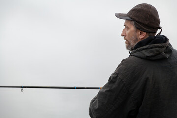 Portrait of fisherman with fishing rod on autumn day....