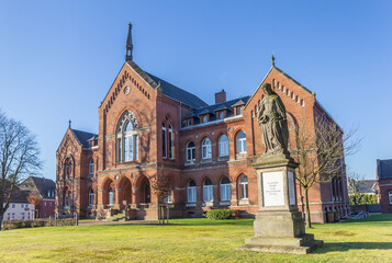 Historic courthouse building and statue in Varel, Germany