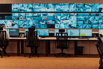 Empty interior of big modern security system control room, workstation with multiple displays,...