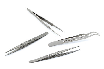 Various tweezers isolated on white background.	