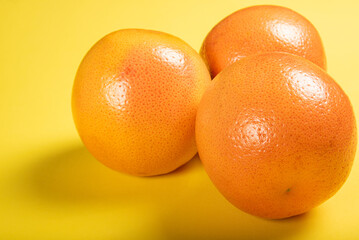 Grapefruit, grapefruits positioned on yellow EVA surface, selective focus.