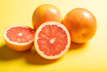 Grapefruit, grapefruits positioned on yellow EVA surface, selective focus.