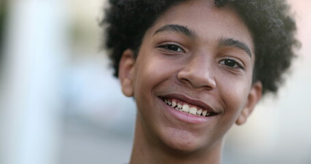 Child boy smiling to camera portrait, mixed race kid, ethnically diverse boy smile outside