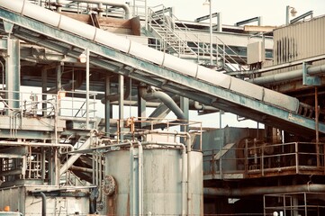 Fototapeta premium Old faded grey metal industrial building rusty