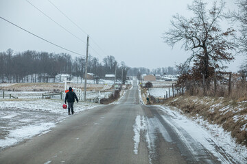 Amish boy walking to school on a snowy day in Holmes County, Ohio