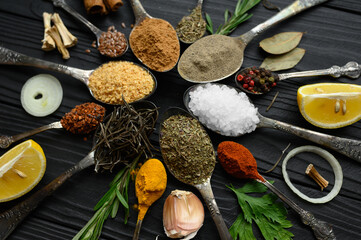 Fototapeta na wymiar Colorful various herbs and spices for cooking on dark wooden rustic background