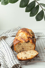 Fresh banana bread on the white background. Homemade pastry on the checkered cloth